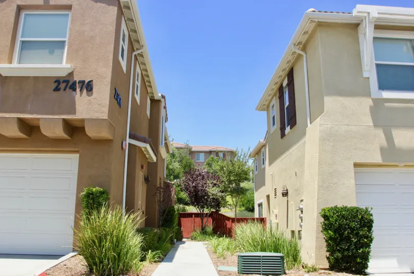 neat walk way and brown, creamy walls of the apartment buildings at North Oaks community, murrieta, California