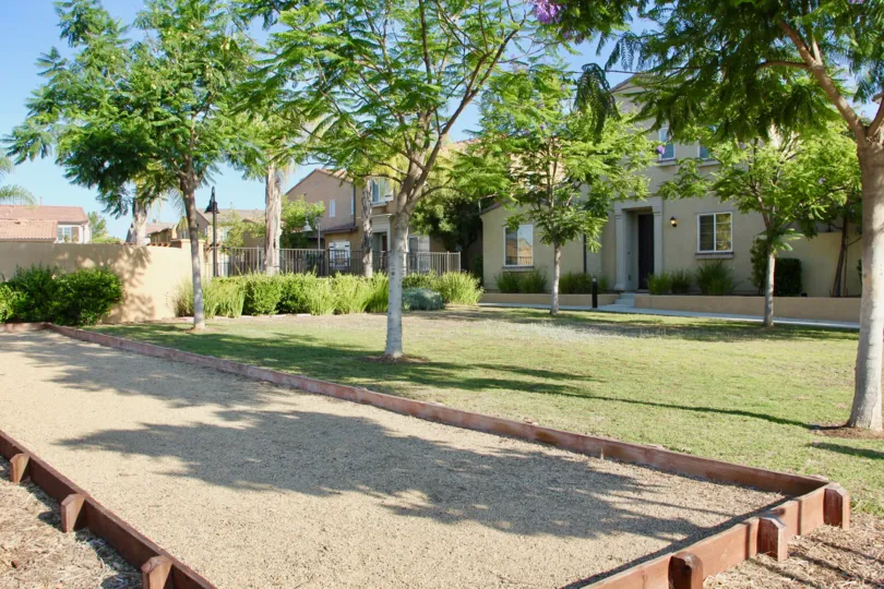 Newer townhomes and trees surround a horseshoe court at Paseos at Crown Valley