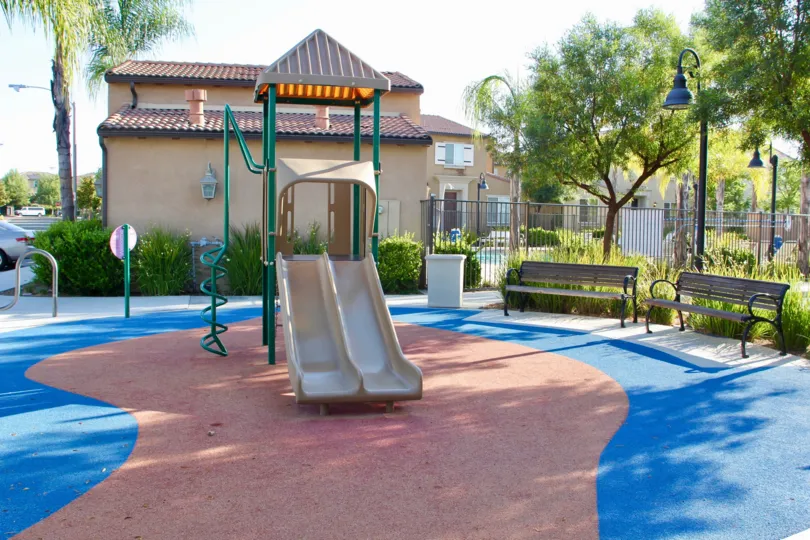 A beautiful view of a kids park in a sunny day. Green trees around and lampposts
