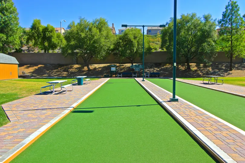 Benches and lightpoles line the areas around the Lawn Bowling courts of the Retreat at Bear Creek