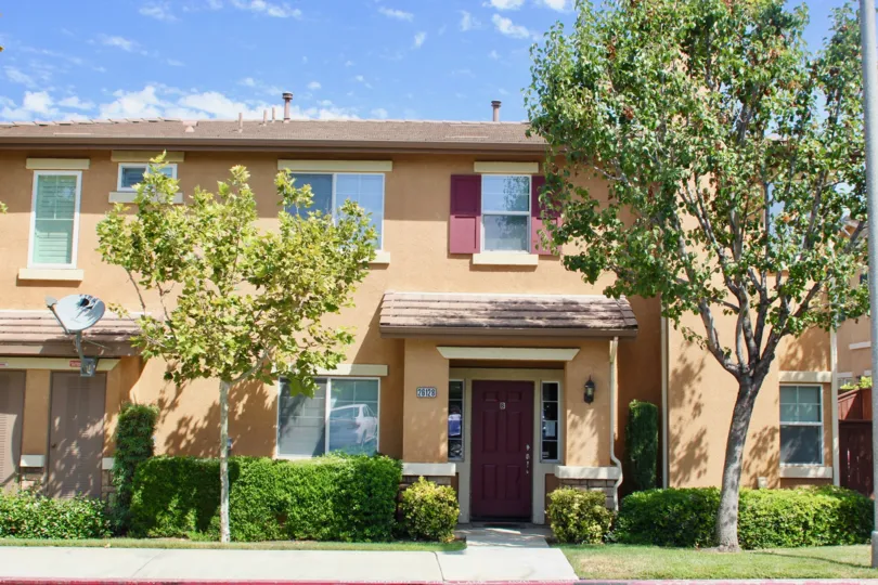 Brown walls and green neighborhood of Villas at Old School House, Murrieta, California