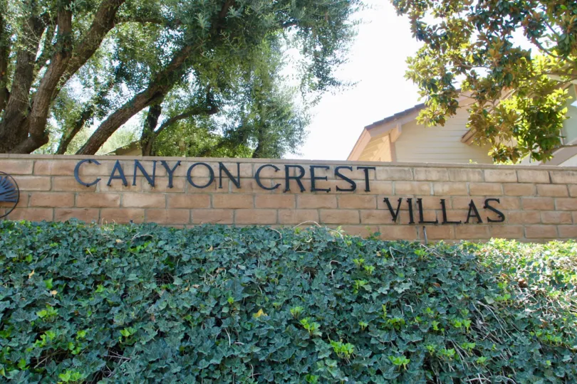Bushes sit in front of a wall at the Canyon Crest Villas.