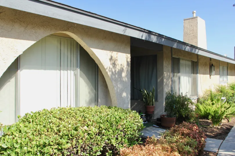 A beige chimney sits on top of a roof of a one story building at Casa De Oro.