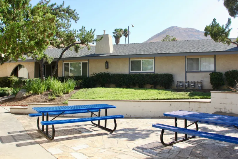 blue seats, green lawn and cute bungalows of Casa De Oro, riverside, California
