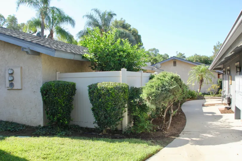 A sunny day in the Casa De Oro neighborhood with homes and shrubs