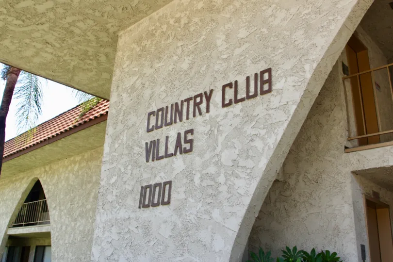 Lettering on entrace reading "Country Club Villas" at the entrance to Country Club Villas in Riverside, California