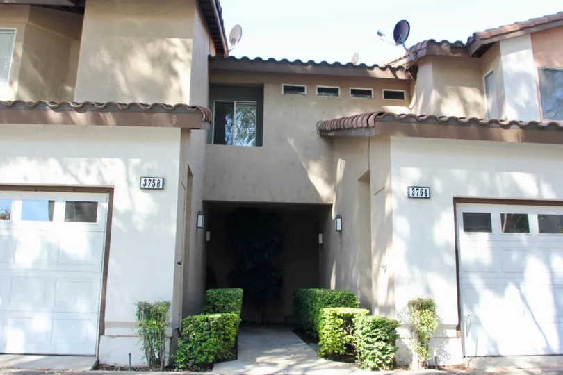 Two adjacent garages, addresses 3758 and 3764 at the Four Seasons Villas in Riverside California