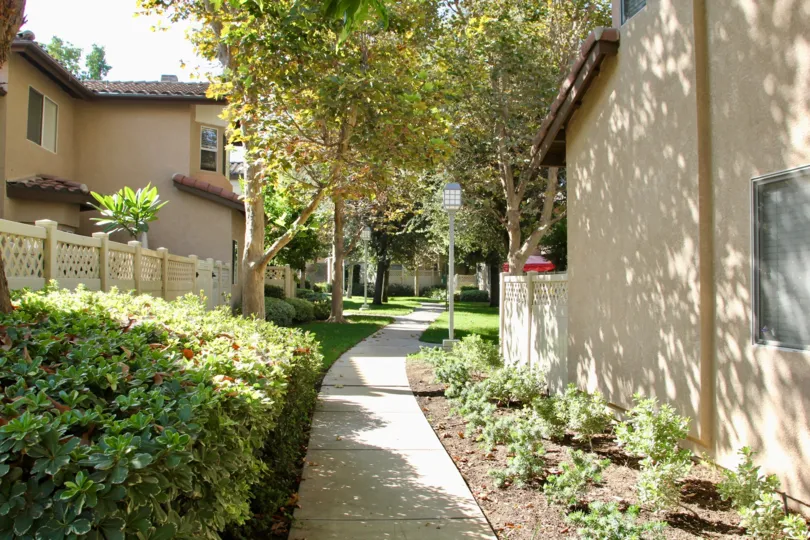 A beige painted privacy fence sits next to a townhouse at the Four Seasons Villas.