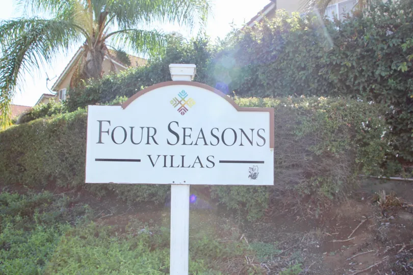 A sunny day in the Four Seasons Villas park with children's playground and picnic tables