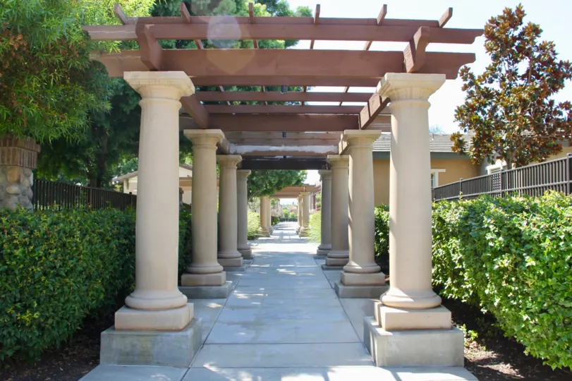 the image contains the lots of pillars and the pillars are beautiful and the walking area are nice to walk with beautiful gardenary,