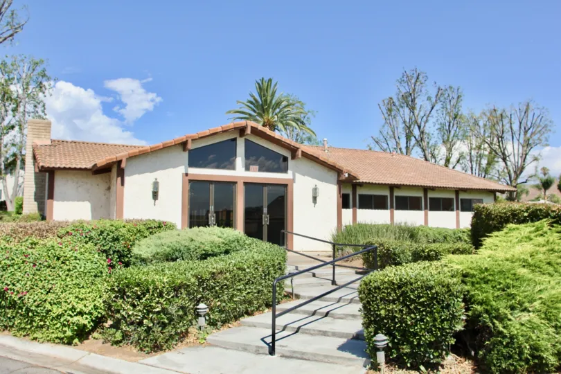 Large, floor to roof windows greet visitors to the entrance of Orangewood Villas in Riverside, California