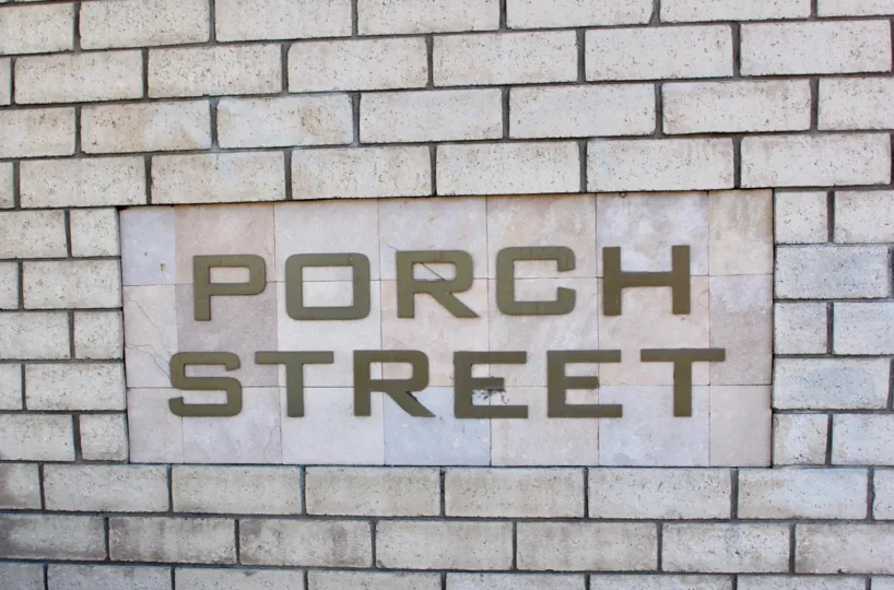 A brick wall with a sign saying Porch Street on it. Found in Riverside, California.