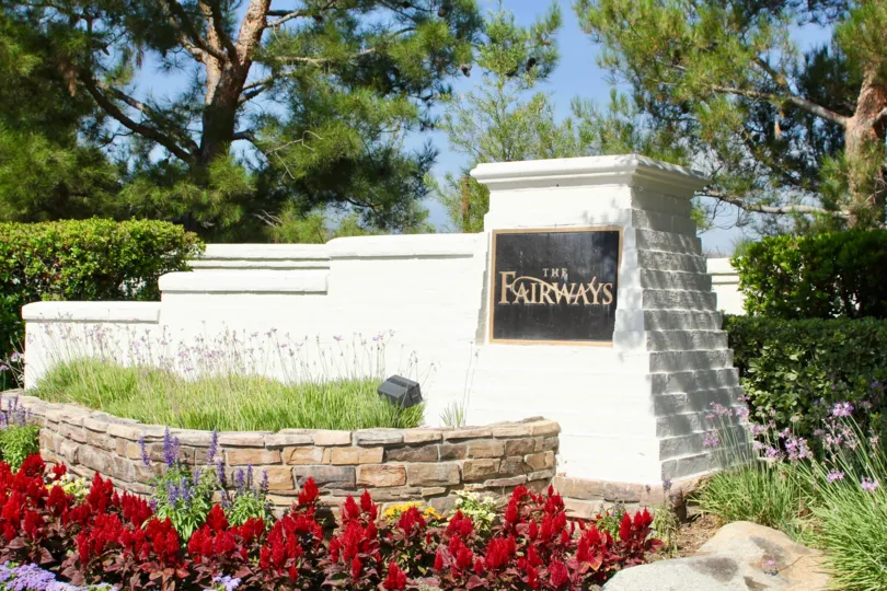 Entrance with garden landscaping and rock wall for Fairways