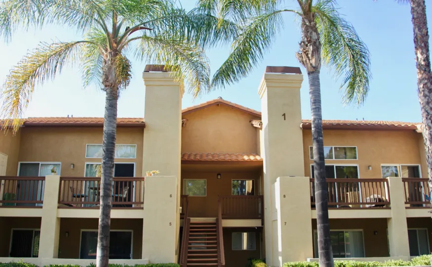the house contains steps at front and trees and grass are surrounded in front of house