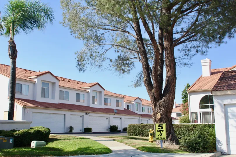 Trees and alleyway accessible garages at Rancho Del Mar