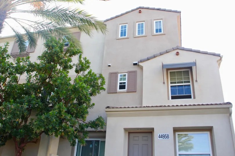A palm tree reflection can be seen in a window at Reflections at Temecula Lane.