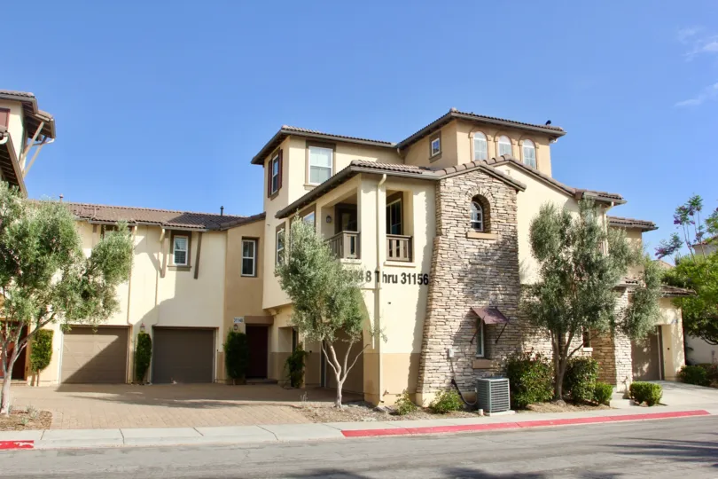 The entrance at Reflections at Temecula Lane with driveway and garage doors