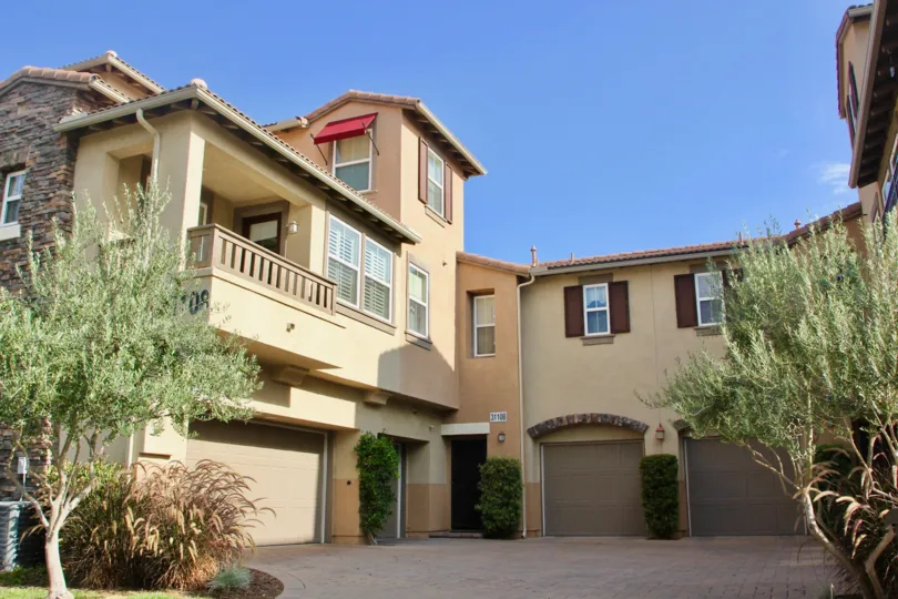 A community courtyard leading to individual garages at Reflections at Temecula Lane in Temecula, California