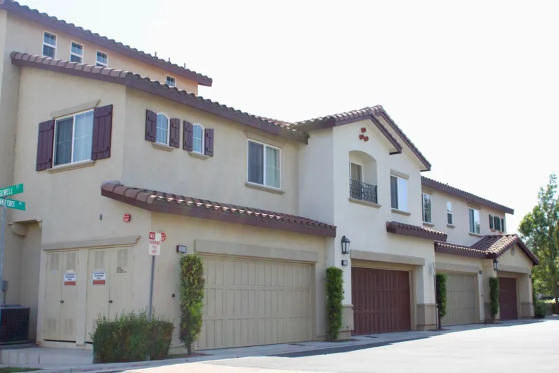 Beautiful Spanish-style building with dark brown garage doors