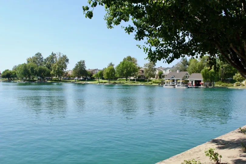 A view of a lake with houses on the banks in Savannah at Harveston community.