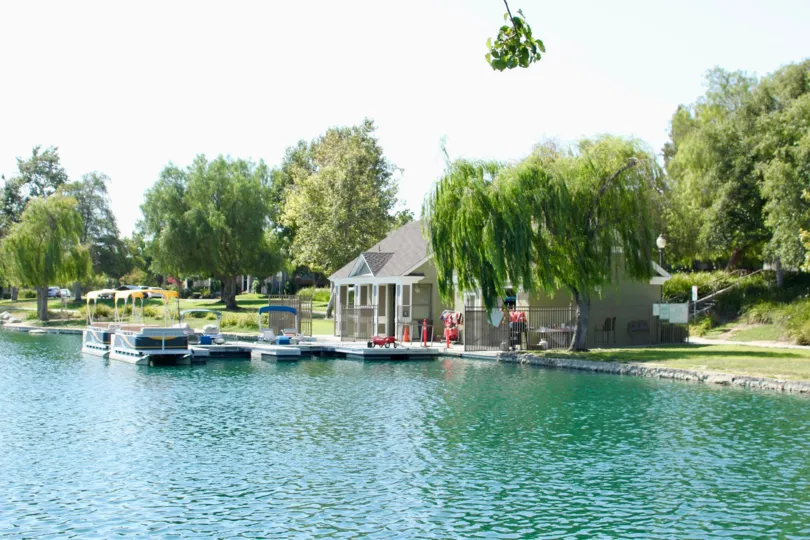 beautiful landscape in front of house and there is a water and boat in front