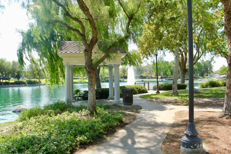 A winding walkway along a large emerald lake inside Savannah at Harveston.