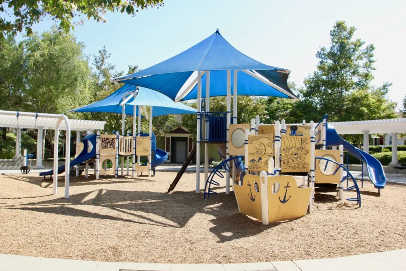 A nice day in the Savannah at Harveston community with a children's playground and pergolas.