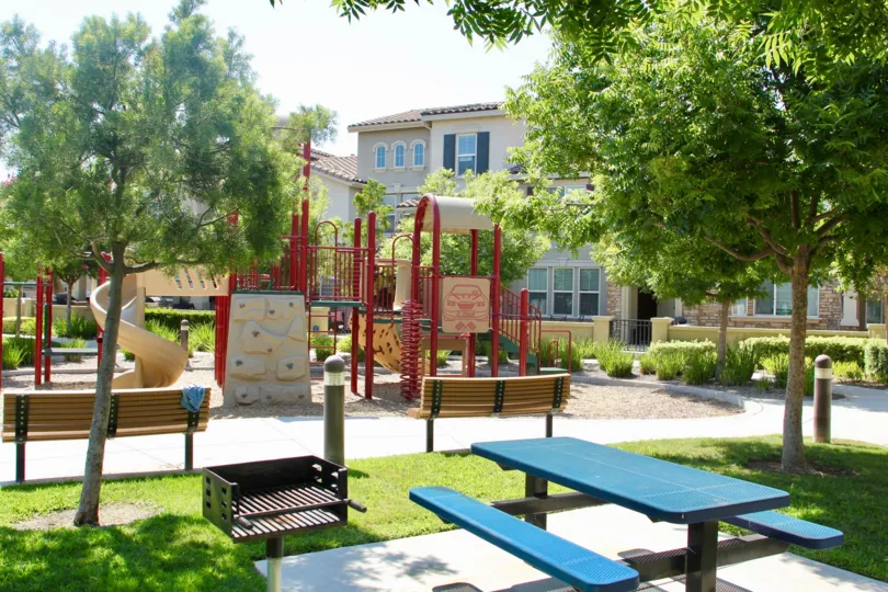 Houses overlook the lighted children's playground and picnic area at Savannah at Harveston in Temecula, California