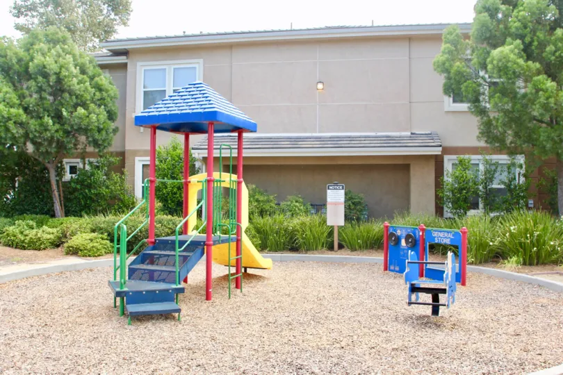Playground for children with green grass and landscaping