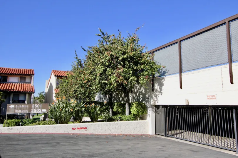 Two homes behind a large parking structure in 2500 Navarra in Carlsbad CA