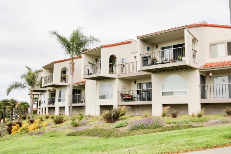 A sunny day in the area of Alta Mira II, condo, palm trees, balconies, grill, furniture