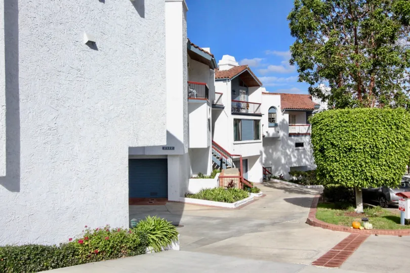 Two-storey townhomes with white walls and tile roofing in Alta Verde neighborhood.