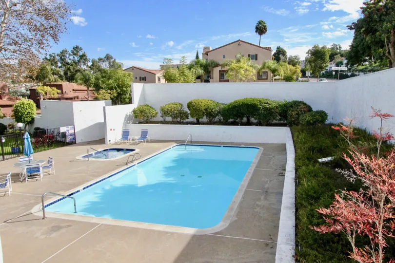 Sunny sky with clouds and a pool in the Alta Verde Community in Carlsbad, CA.