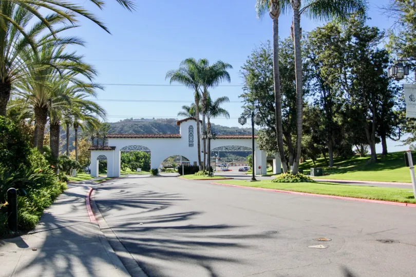Sunny day with beautiful view of trees and garden with entrance in Balboa Building of Carlsbad