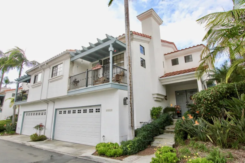 A sunny day in the Bel Azure with large house and garage door.