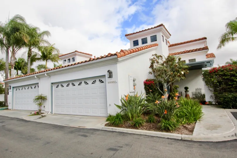 A two-storey residence with white walls and tile roofing in the Bel Azure neighborhood.