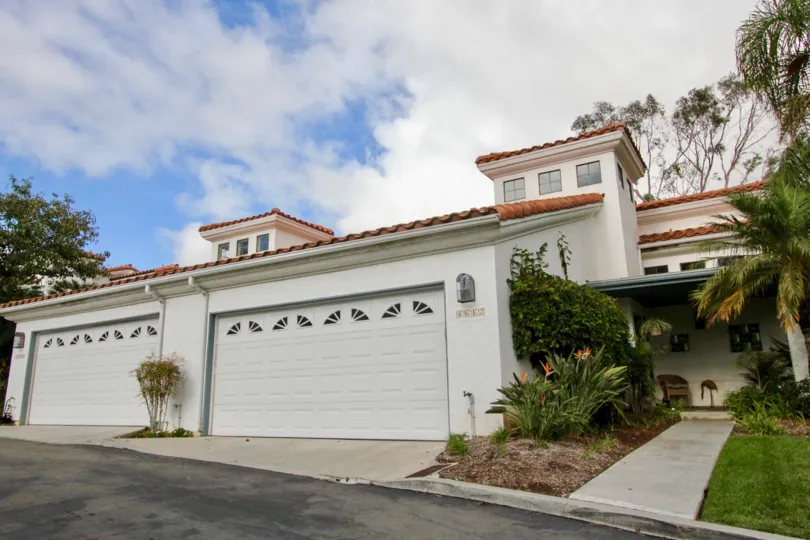A bungalow with closed garage and ceramic tile roofing in the Bel Azure neighborhood.