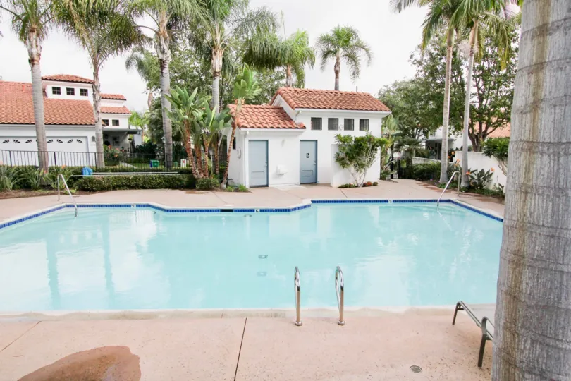 A nice day in front of a pool and pool house at Bel Azure home