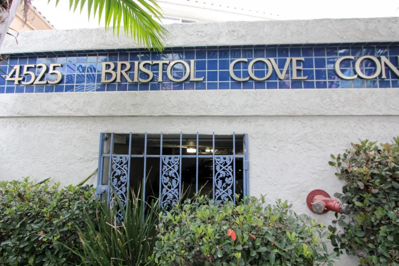 View into a parking lot with bushes in the Bristol Cove Community in Carlsbad, CA.