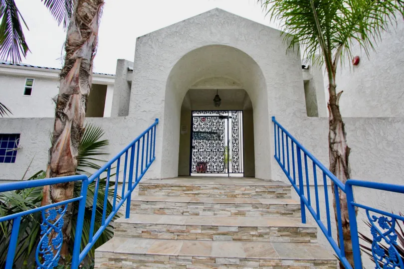 An arched gateway with blue railings in the Bristol Cove neighborhood.