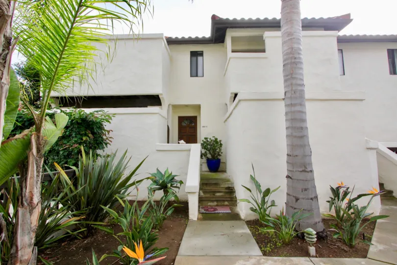 A day in the Carlsbad Beach Villas with a house and plants.