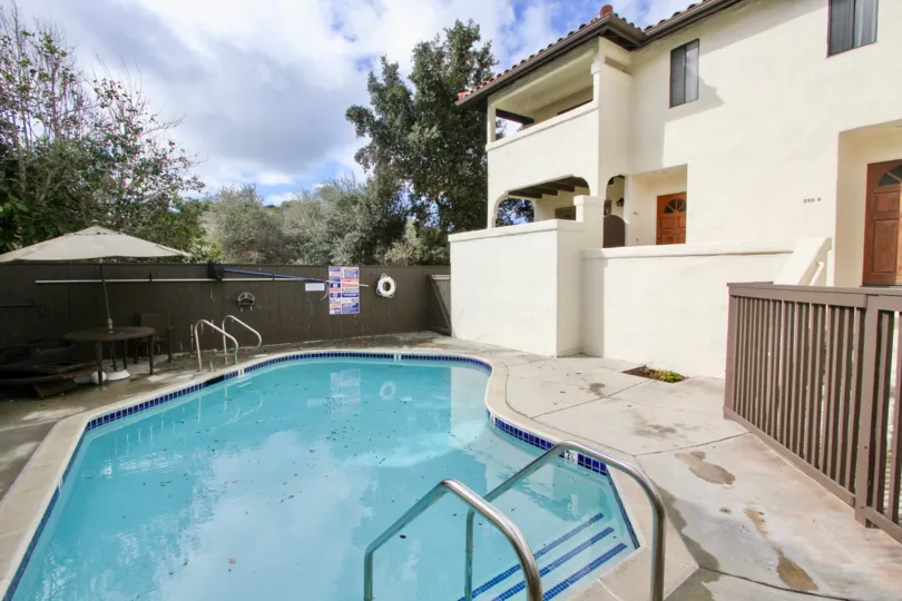 A sunny day in the area of Carlsbad Beach Villas, condo, outside, palm trees, windows, balcony