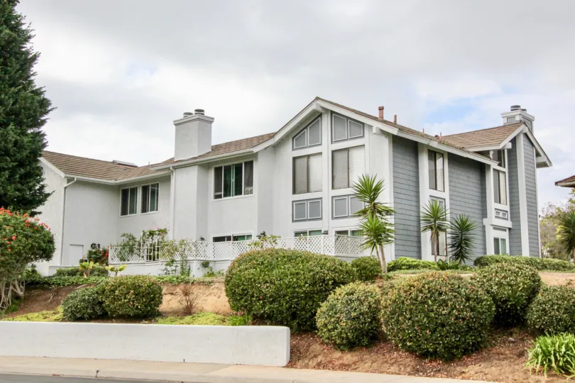 A cloudy day in the Carlsbad Crest with a big house and garden.