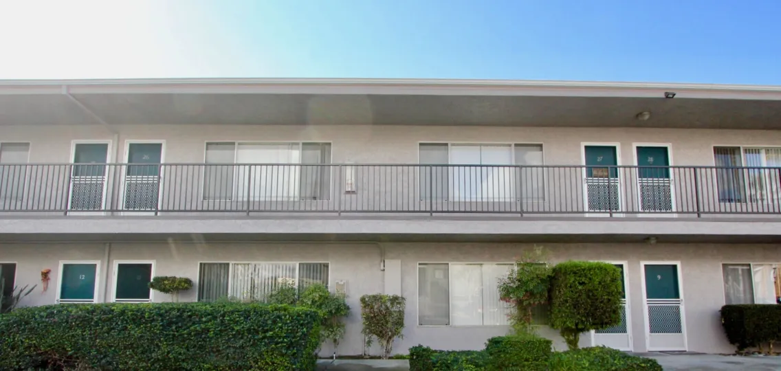 A building with green trees in front in Casa De La Playa of Carlsbad