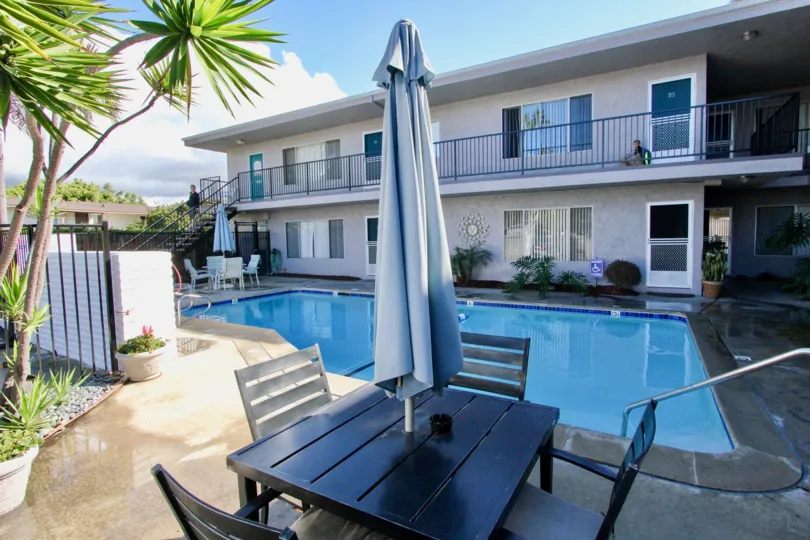 View of swimming area of a Casa De La Playa motel with seating area