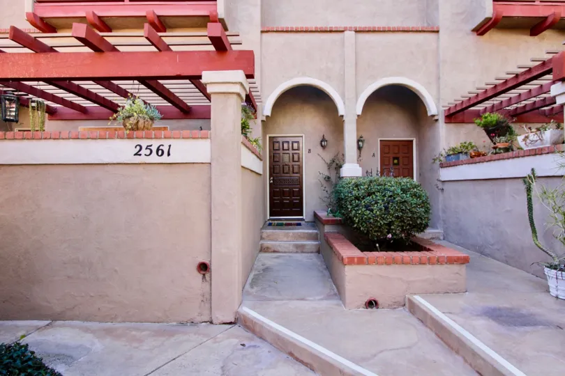 THE 2561 BUILDING IN THE FAIRWAYS SOUTH WITH THE WOODEN DOOR, PLANTS, FLOWER POT