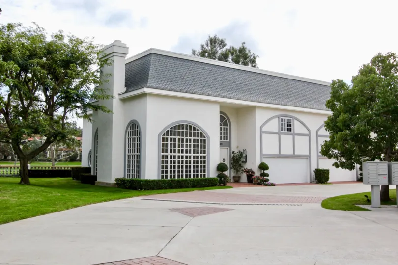 A beautiful day in the Jockey Club with a house and trees.