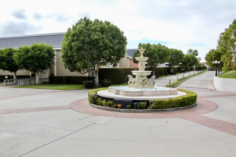 A bright day in the Jockey Club with water fall and trees.