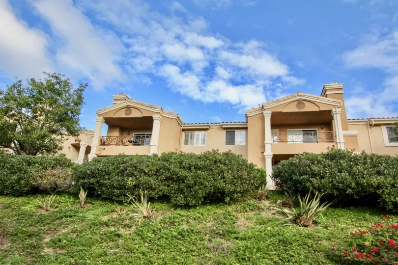A large building in the La Costa Alta community on a cloudy day in Carlsbad California