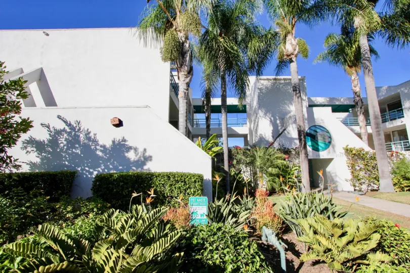 A BEAUTIFUL FRONT SIGHT OF AN APARTMENT WITH HUGE GREEN AREA